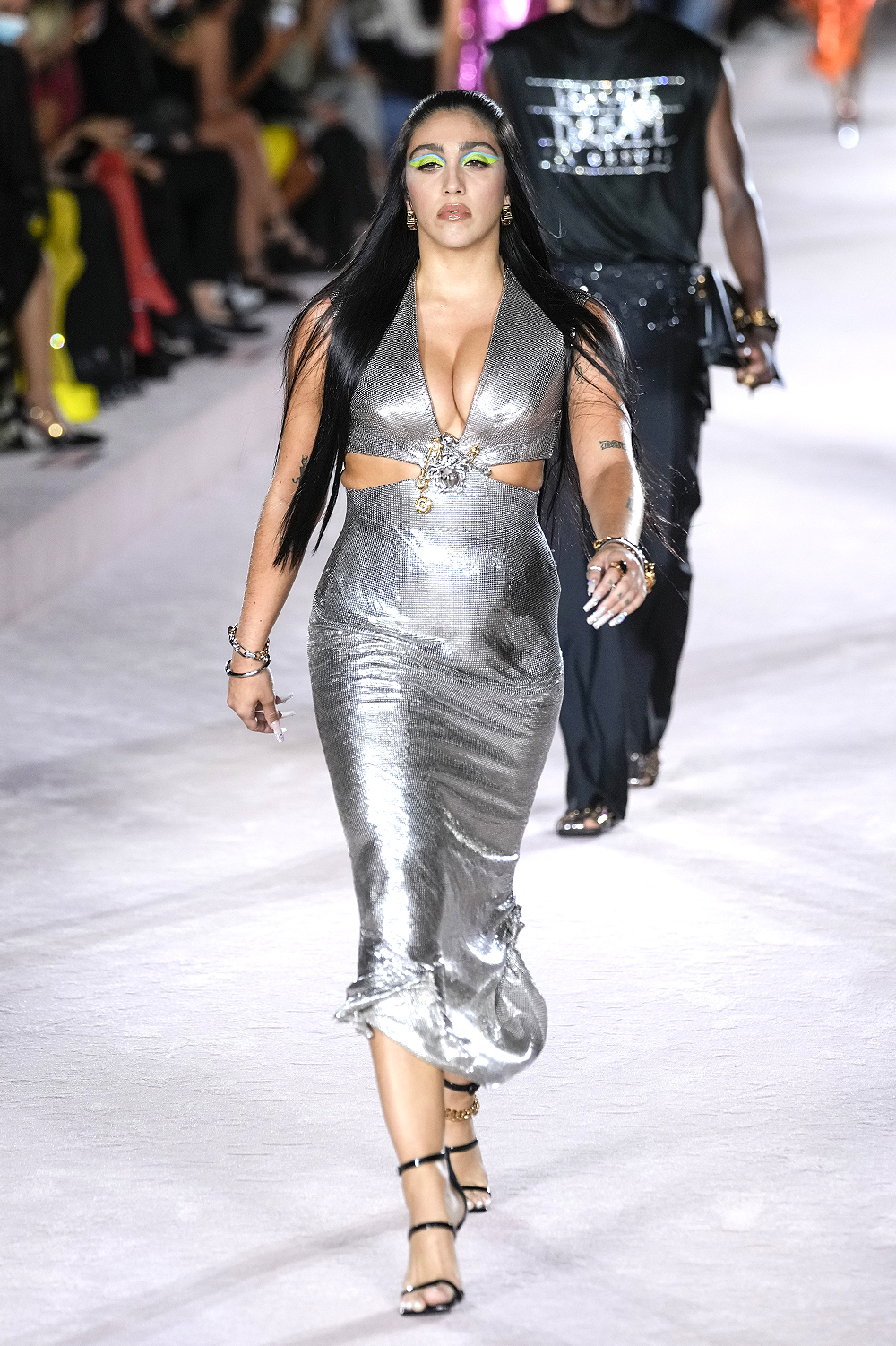 Lourdes Leon wears a plunging silver dress as she walks the runway for Versace at Milan Fashion Week