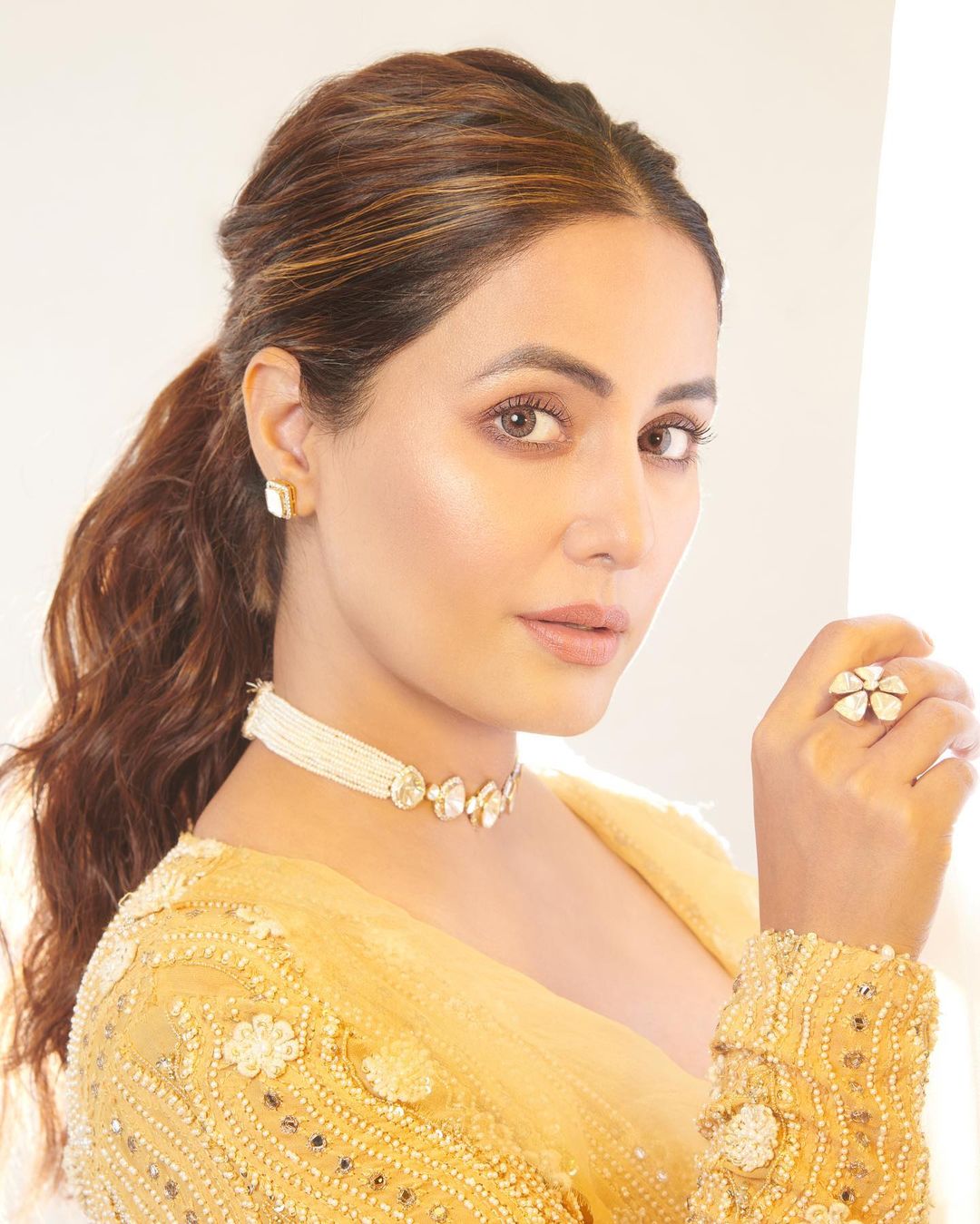 Hina Khan accessorises her look with a choker, pair of studs and floral ring.