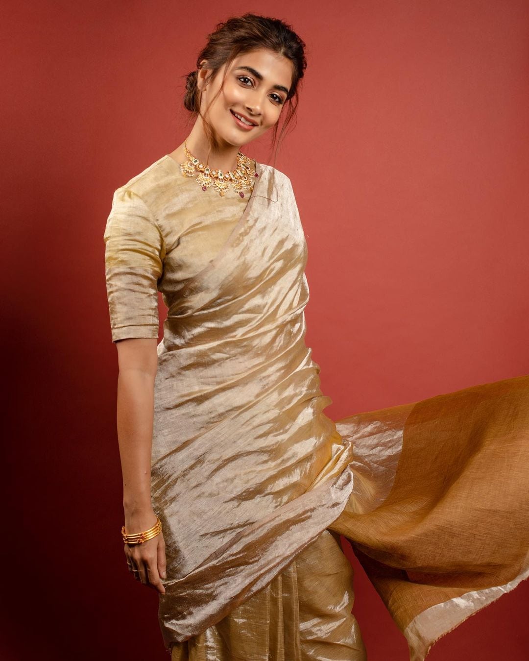 Pooja Hegde looks graceful in the golden tissue saree