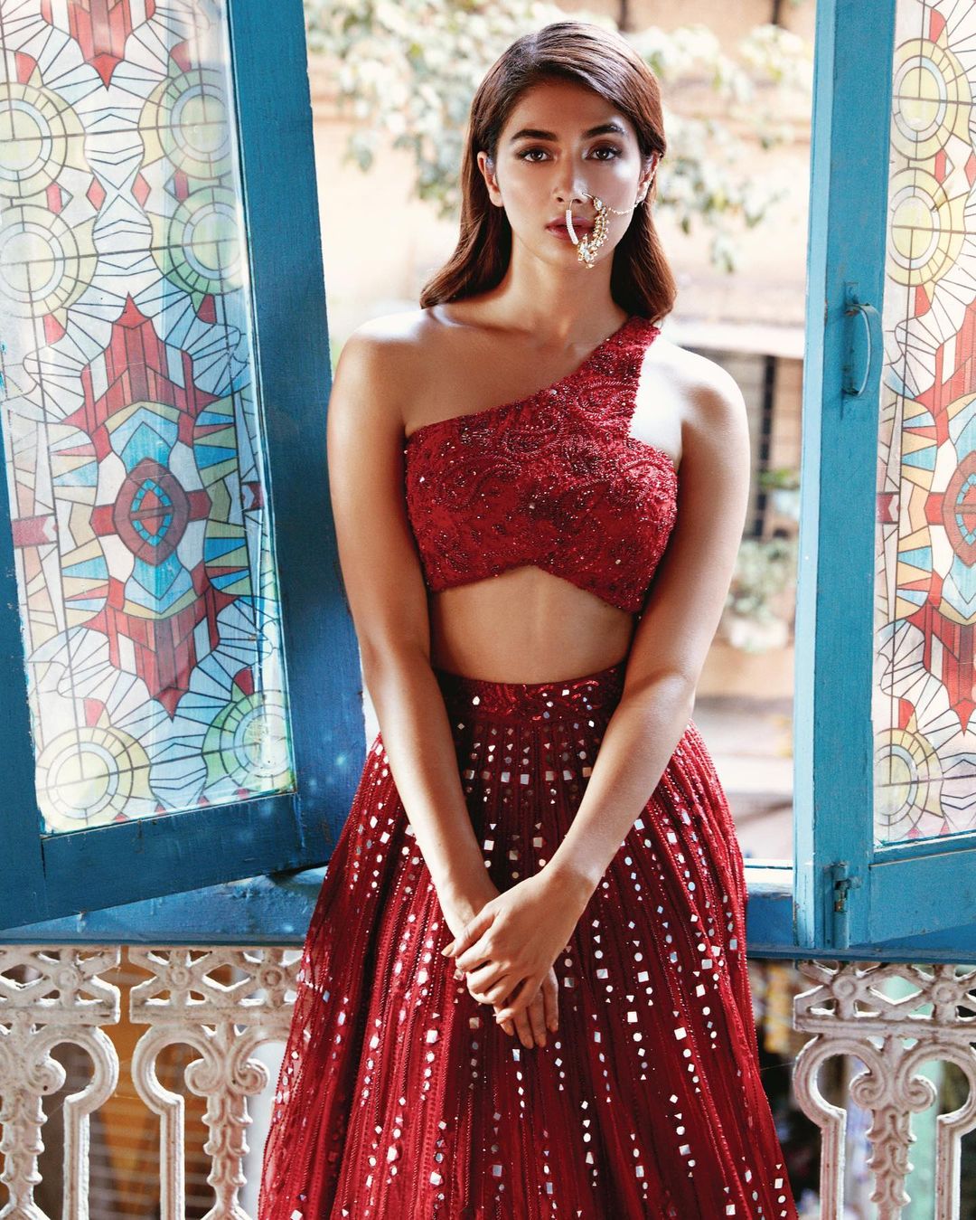 Pooja Hegde looks super sultry in the deep red lehenga with mirrorwork.