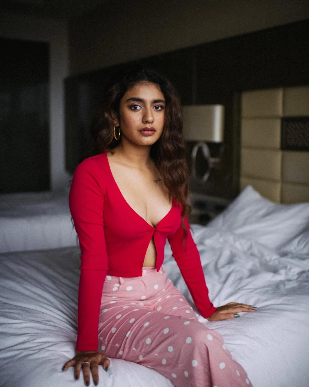 Priya Prakash Varrier drops some smoldering pictures from her latest photoshoot with a red top and pink polka dot trousers.