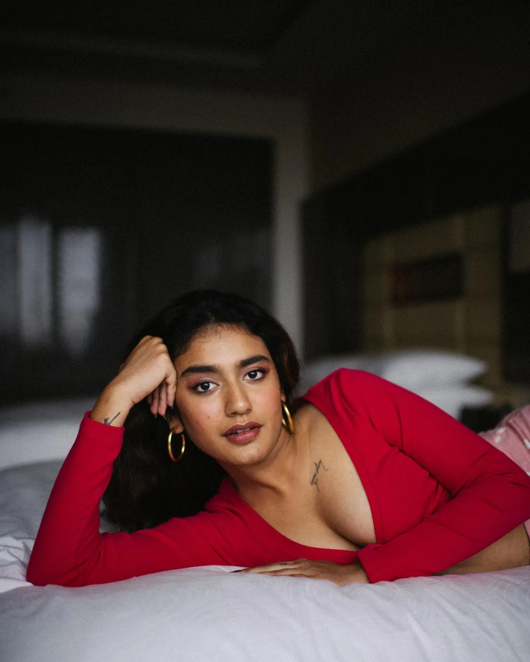 Priya Prakash Varrier looks alluring in a red top with a plunging neckline in her latest PHOTOS