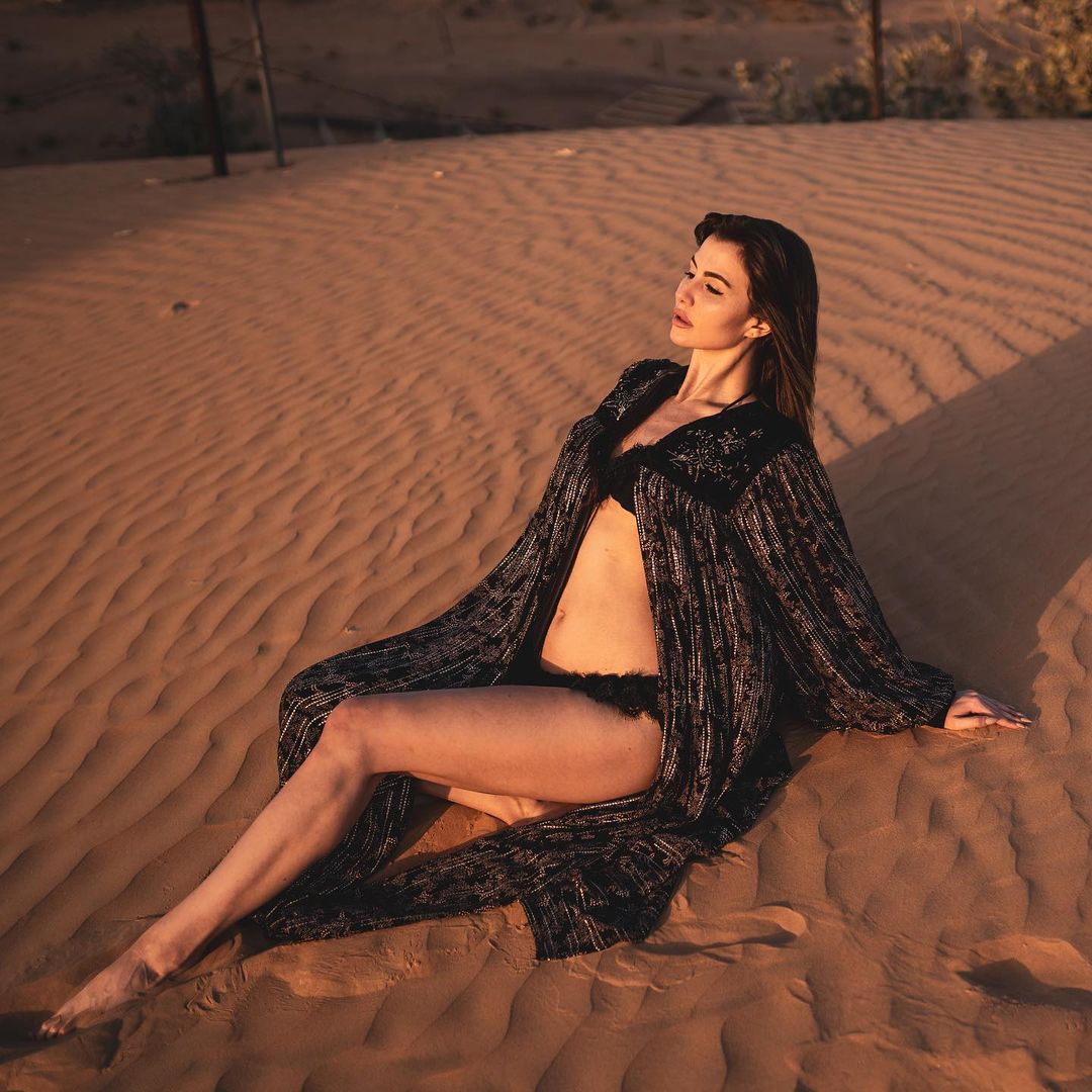 Giorgia Andriani lazes in the sand in a sexy black bikini.
