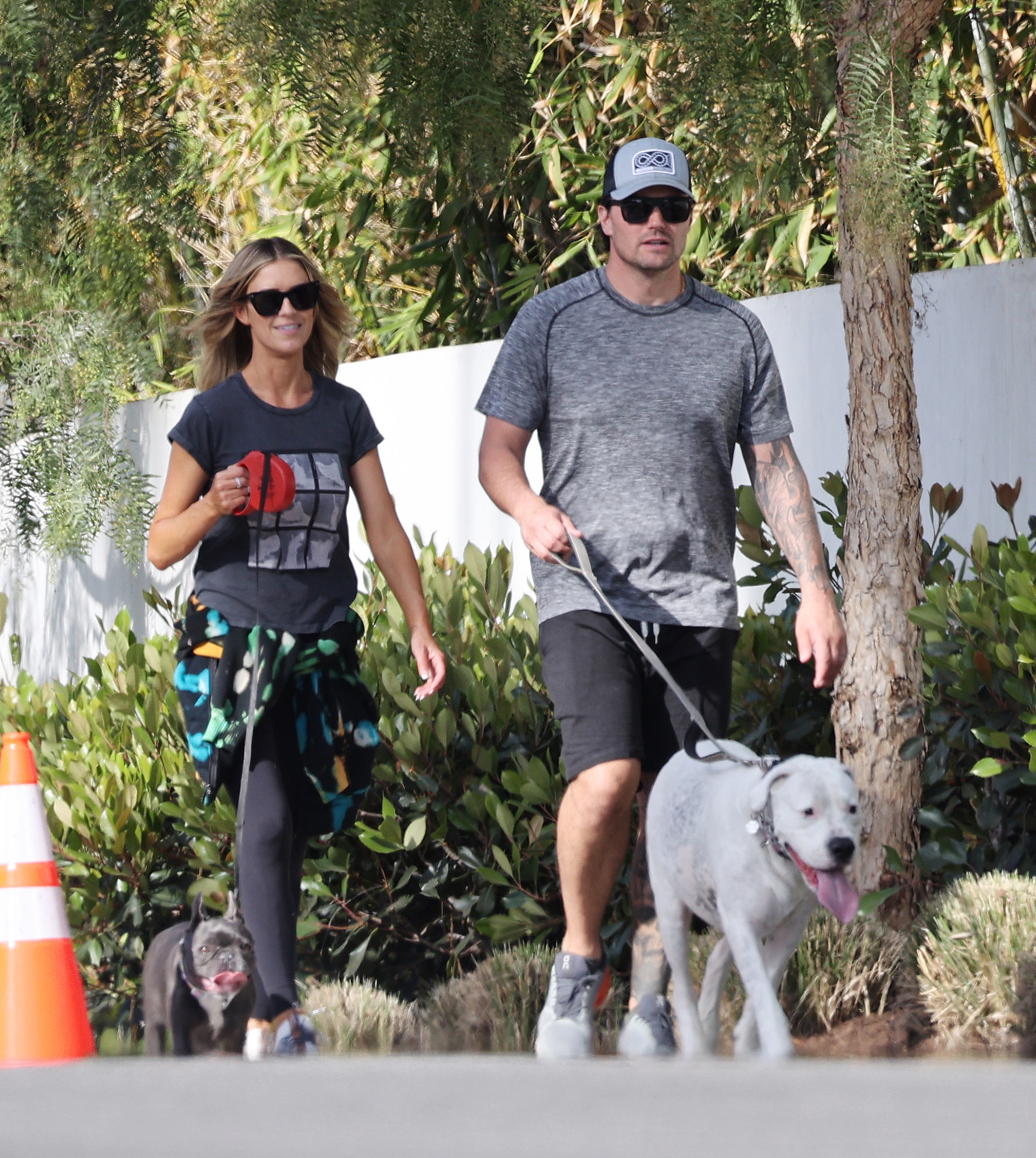Christina Haack and her new husband, Joshua Hall, walk their dogs.