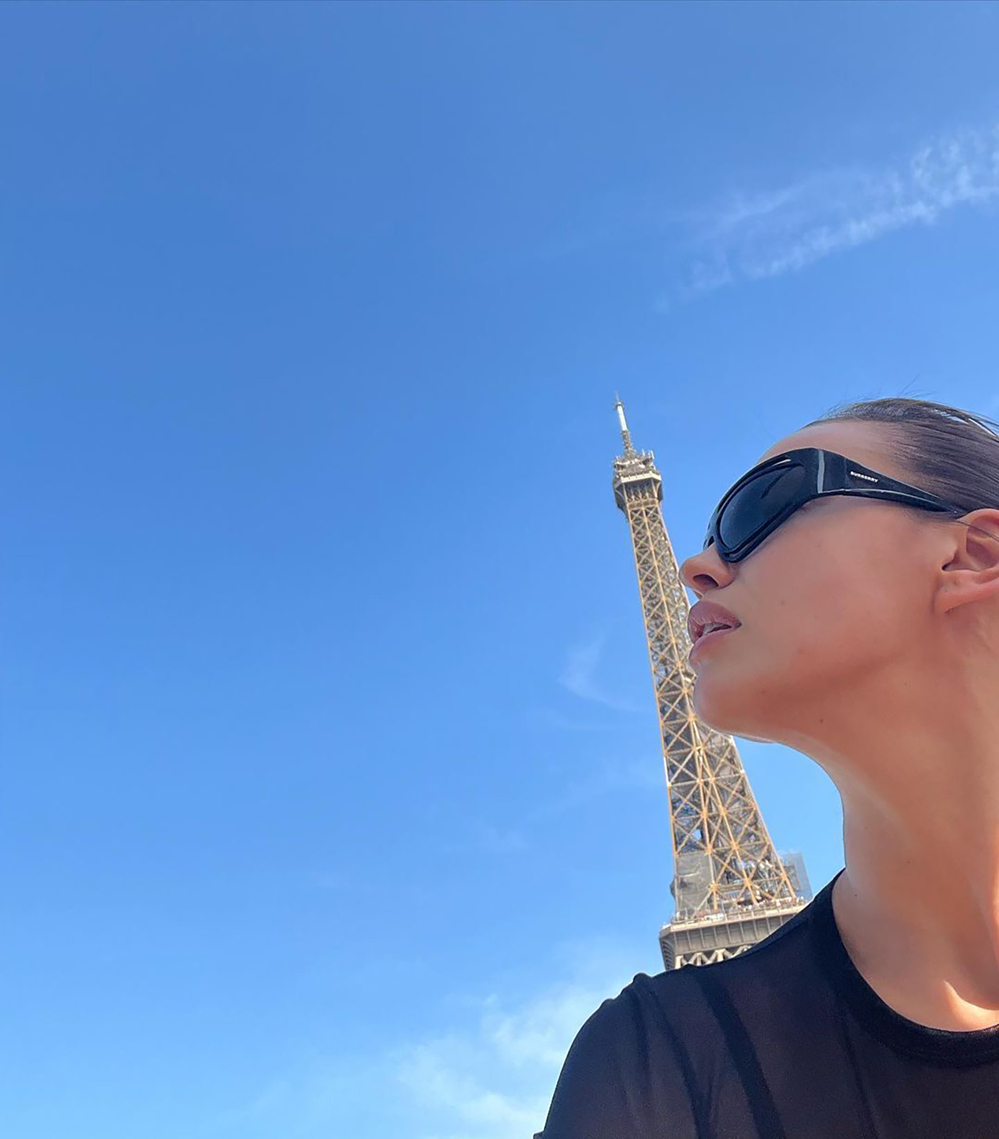 Irina Shayk snaps an artistic selfie in front of the Eiffel Tower.
