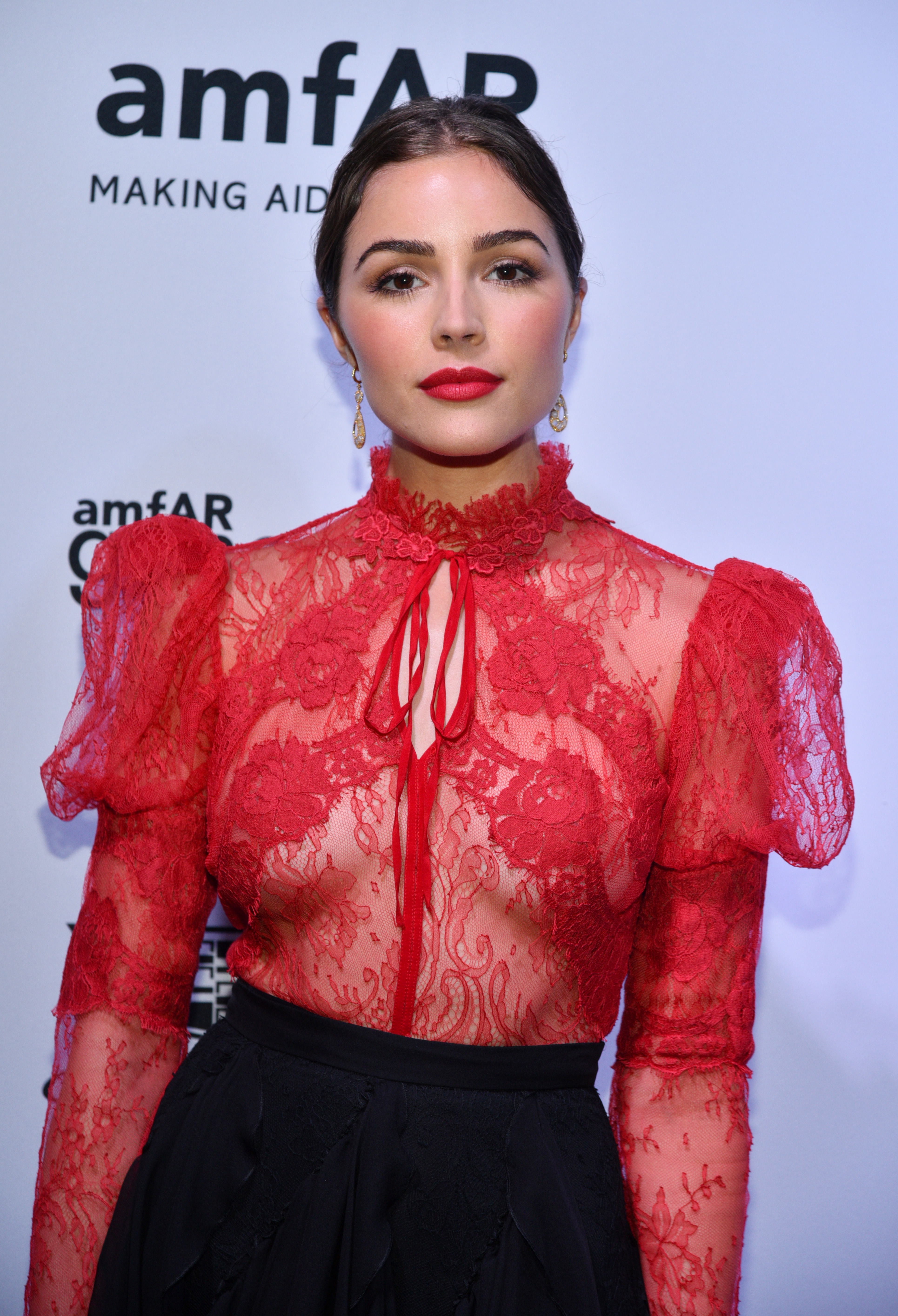 The former Miss Universe really likes see-through red tops, as she wore this sheer lace one with carefully placed appliques to an amfAR event in 2017.
