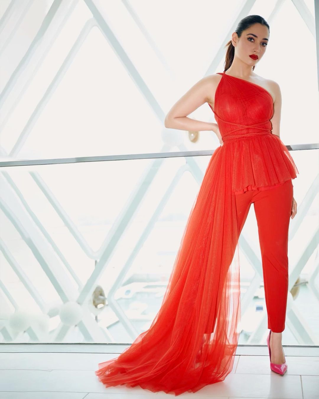 Tamannaah Bhatia looks sexy in the red jumpsuit with a tulle train