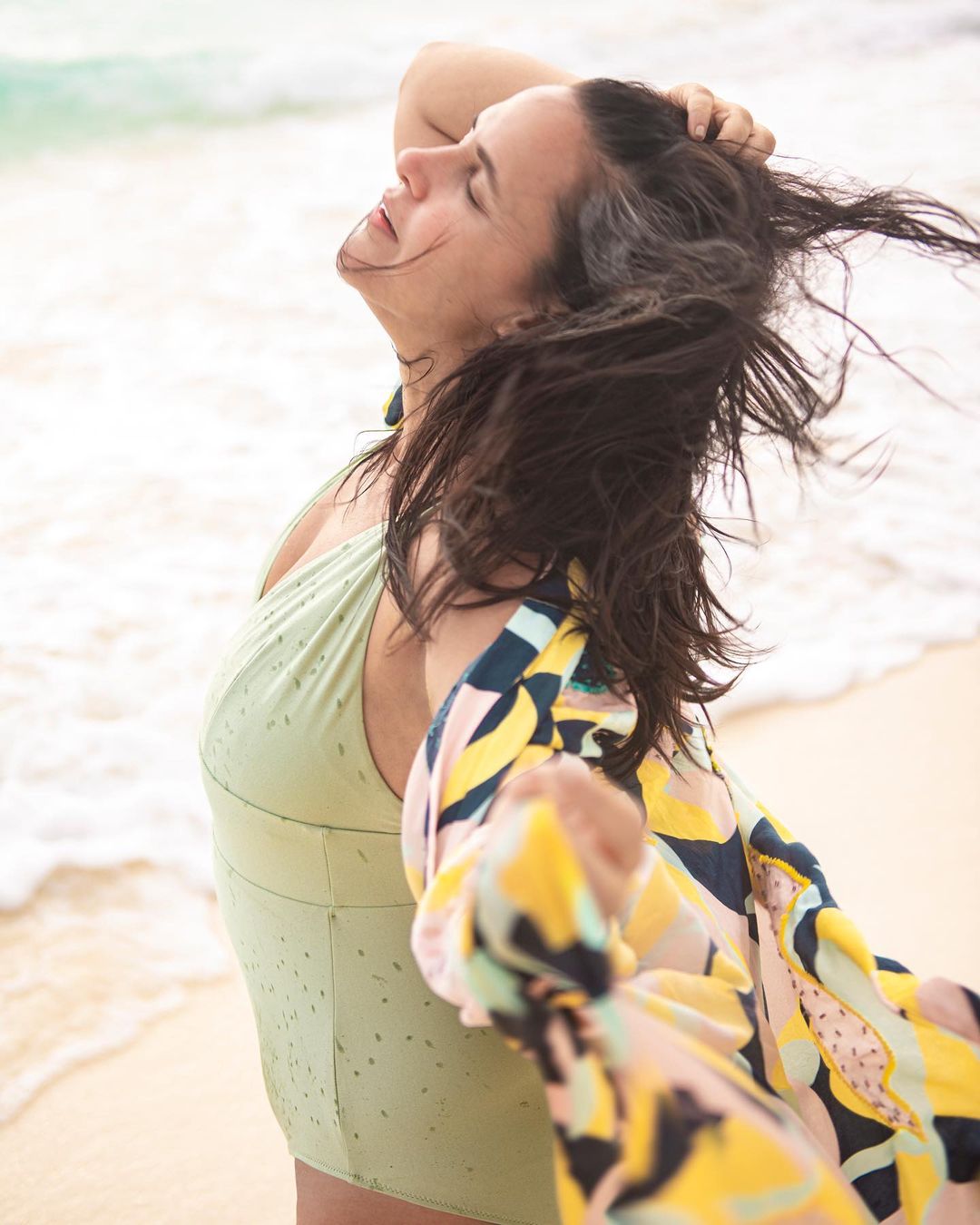 Neha Dhupia clearly seems to be enjoying the sun, sand and sea in these pictures. She donned a mint green bathing suit and paired it with a muti-coloured kimono