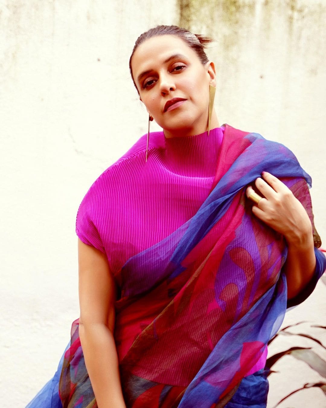 Neha Dhupia recently dazzled in an organza saree that had quirky prints in shades of fuchsia pink, blue, and pickle green.
