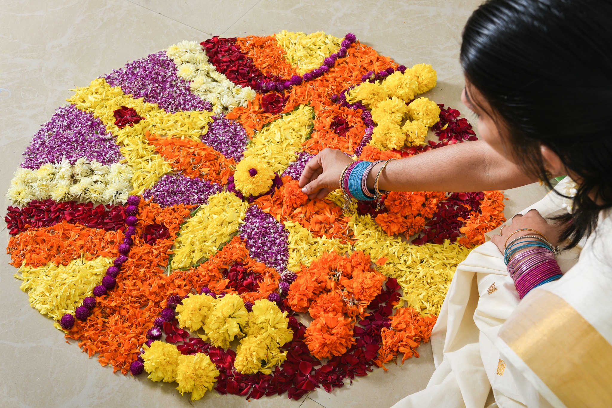 The Onam Pookalam is usually created in a circular shape and then filled with delicate flower petal design