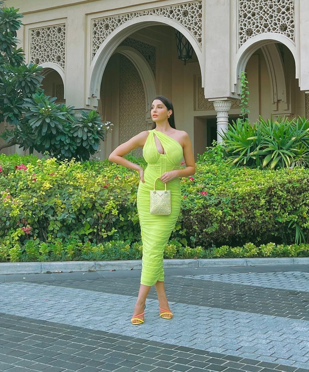 Nora Fatehi flaunts her curves in a neon green bodycon dress.