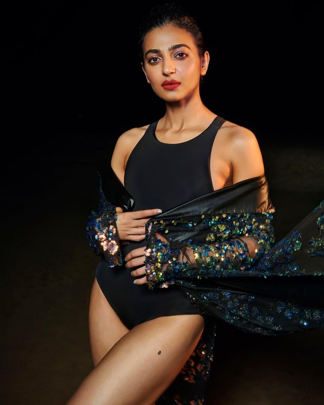 Radhika Apte flaunts her petite frame in a black bodysuit and shimmery shrug.