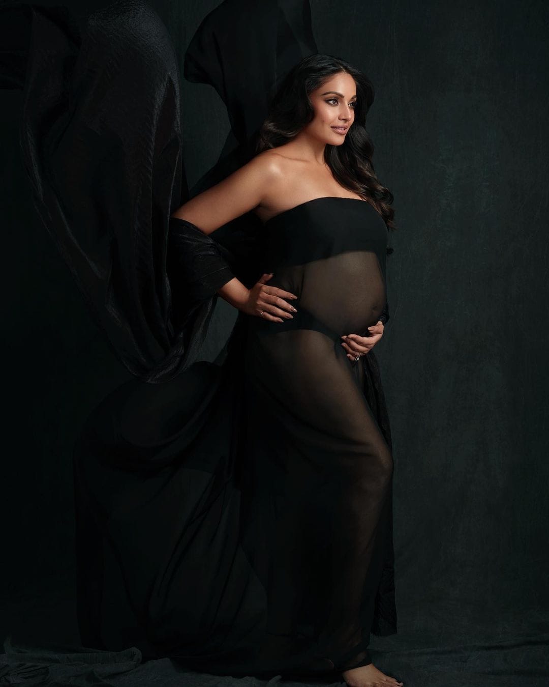Bipasha Basu looks radiant as she flaunts her baby bump in a black sheer dress