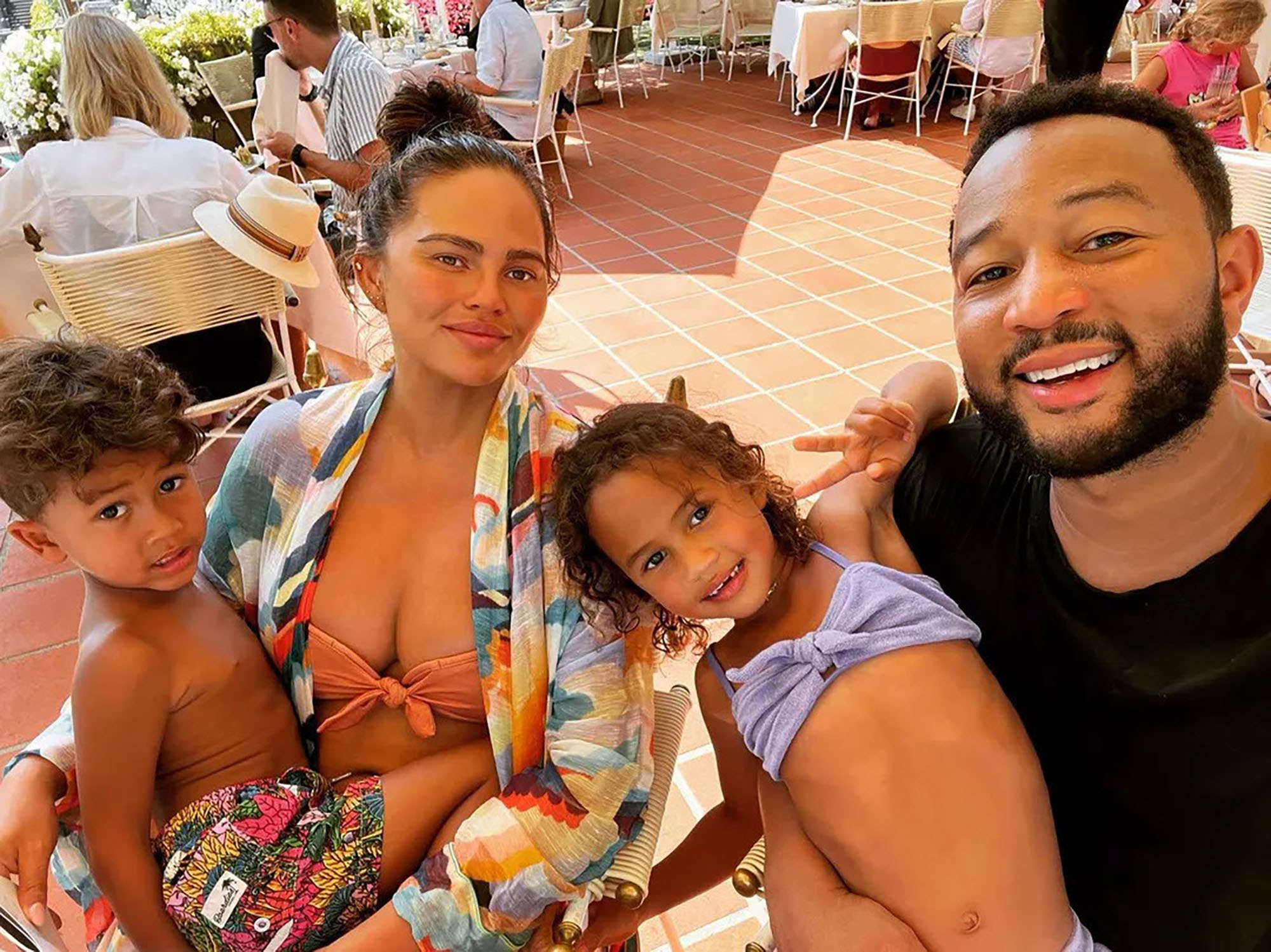 Chrissy Teigen and her changing face continue to enjoy vacation with her family