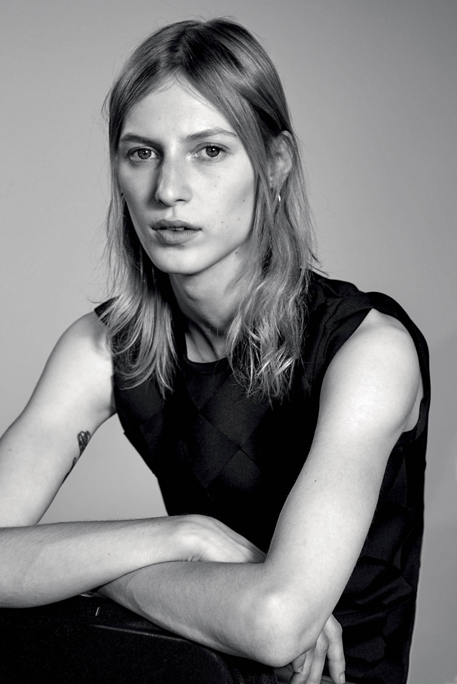 A Melancholic Black And White Shot Of The Australian Model, Julia Nobis, As She Posed Seriously Sitting Down