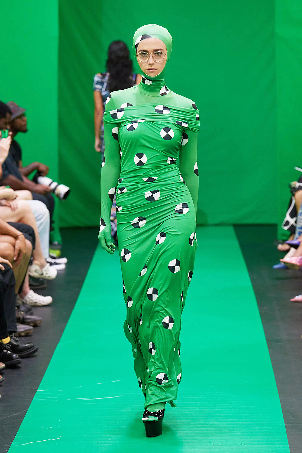 Ella Emhoff walks the NYFW Maisie Wilen Fashion Show. She wore a green gown with black and white patterns.
