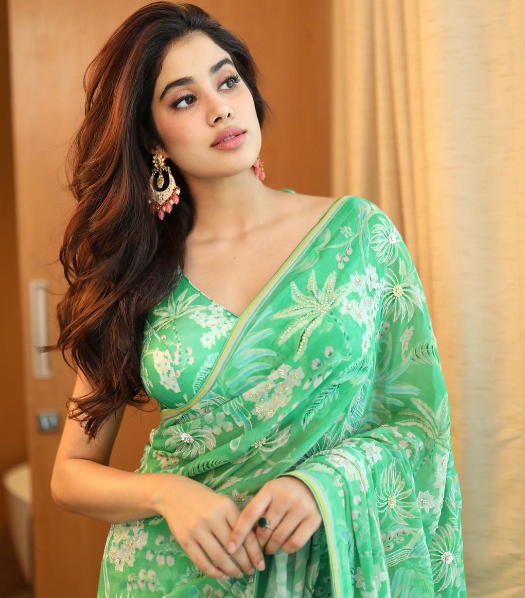 Janhvi Kapoor looks beautiful in the green tropical-themed saree.