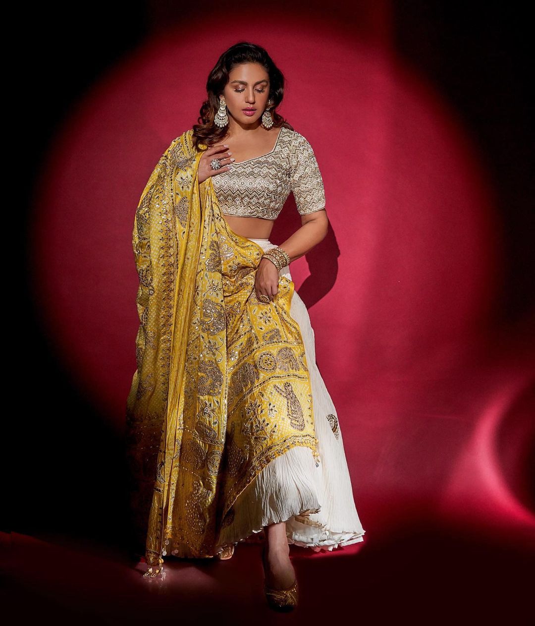 Huma Qureshi looks regal in a white and silver lehenga with yellow dupatta