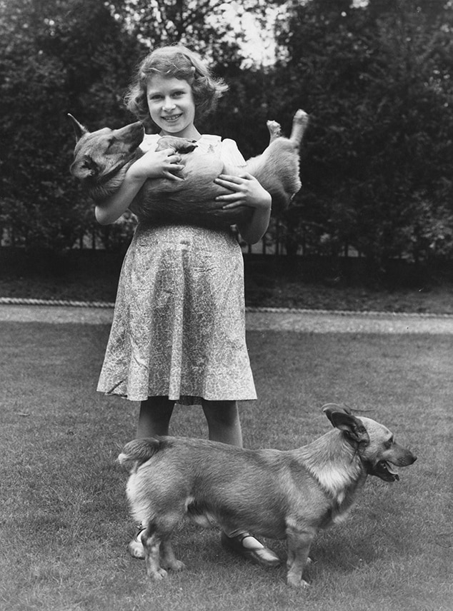 Queen Elizabeth II, then known as Princess Elizabeth, with two corgi dogs in 1936