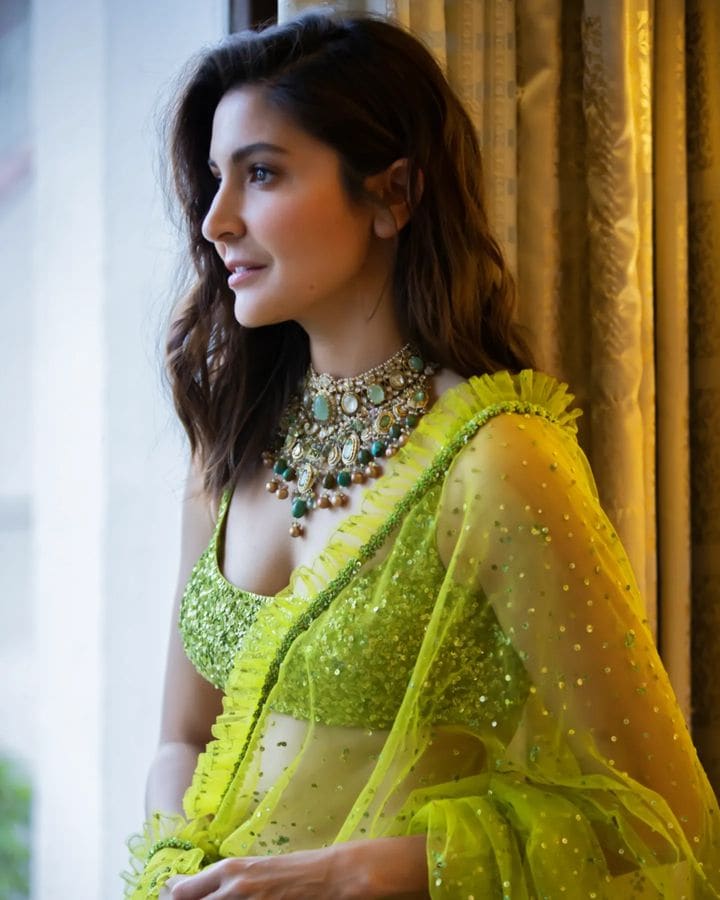 Anushka Sharma accessorised her look with an ornate neckpiece of multicoloured stones.