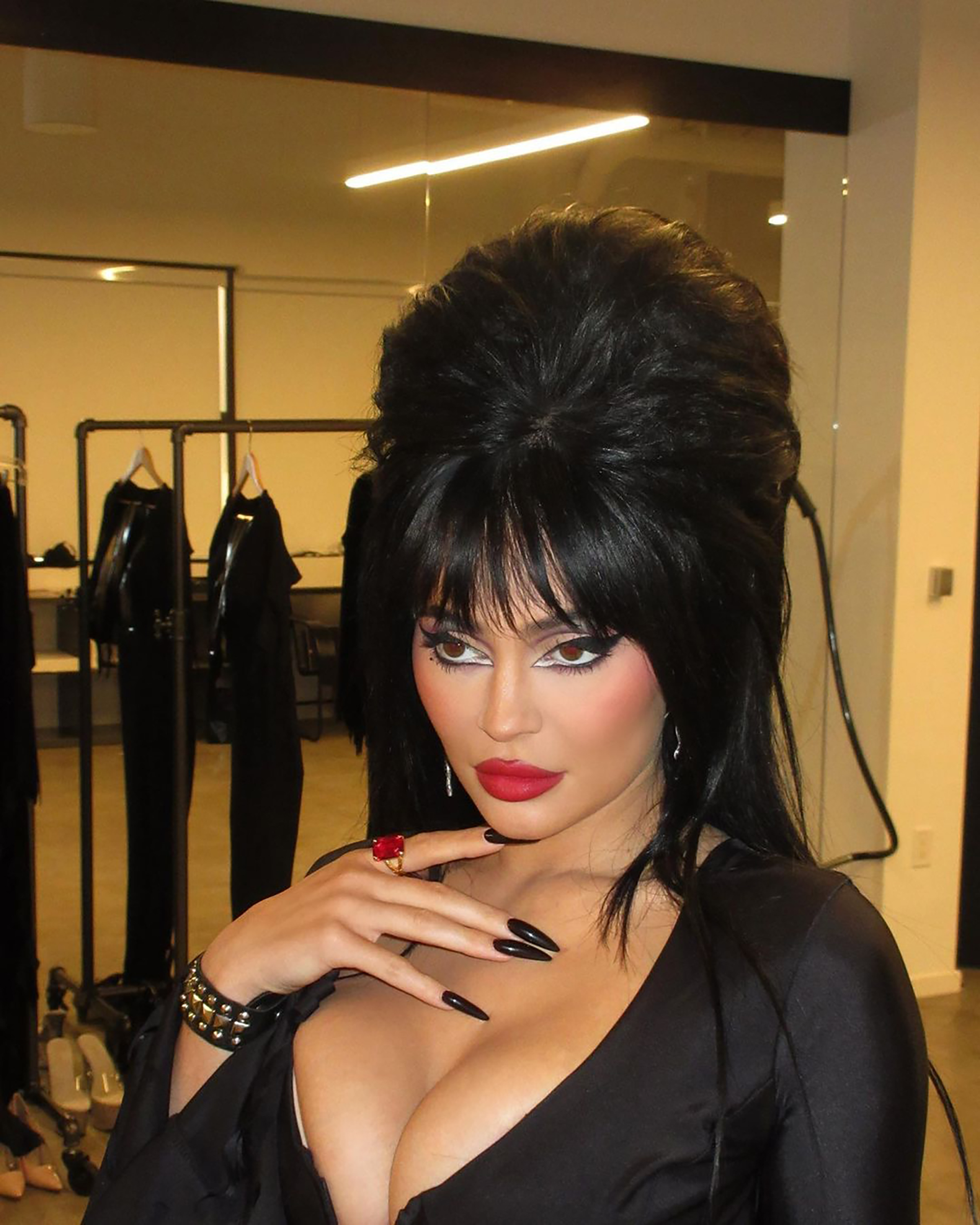 Jenner rocked a plunging black dress much like Elvira's iconic costume