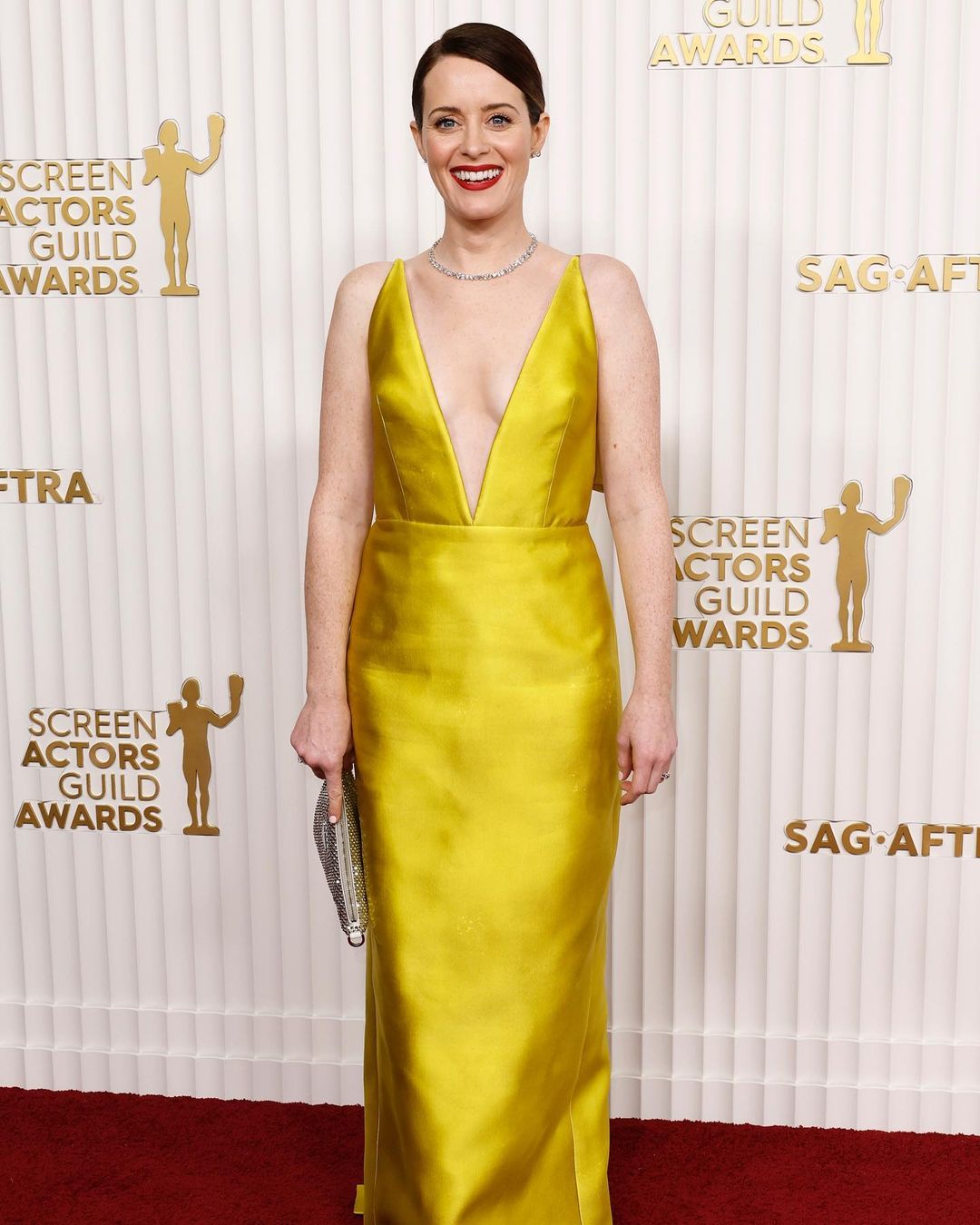 Claire Foy looked gorgeous in a yellow silk dress by Prada