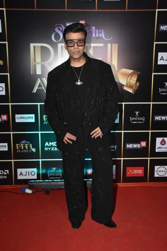 Karan Johar in shimmery black suit at the News18 Showsha Reel Awards 2023