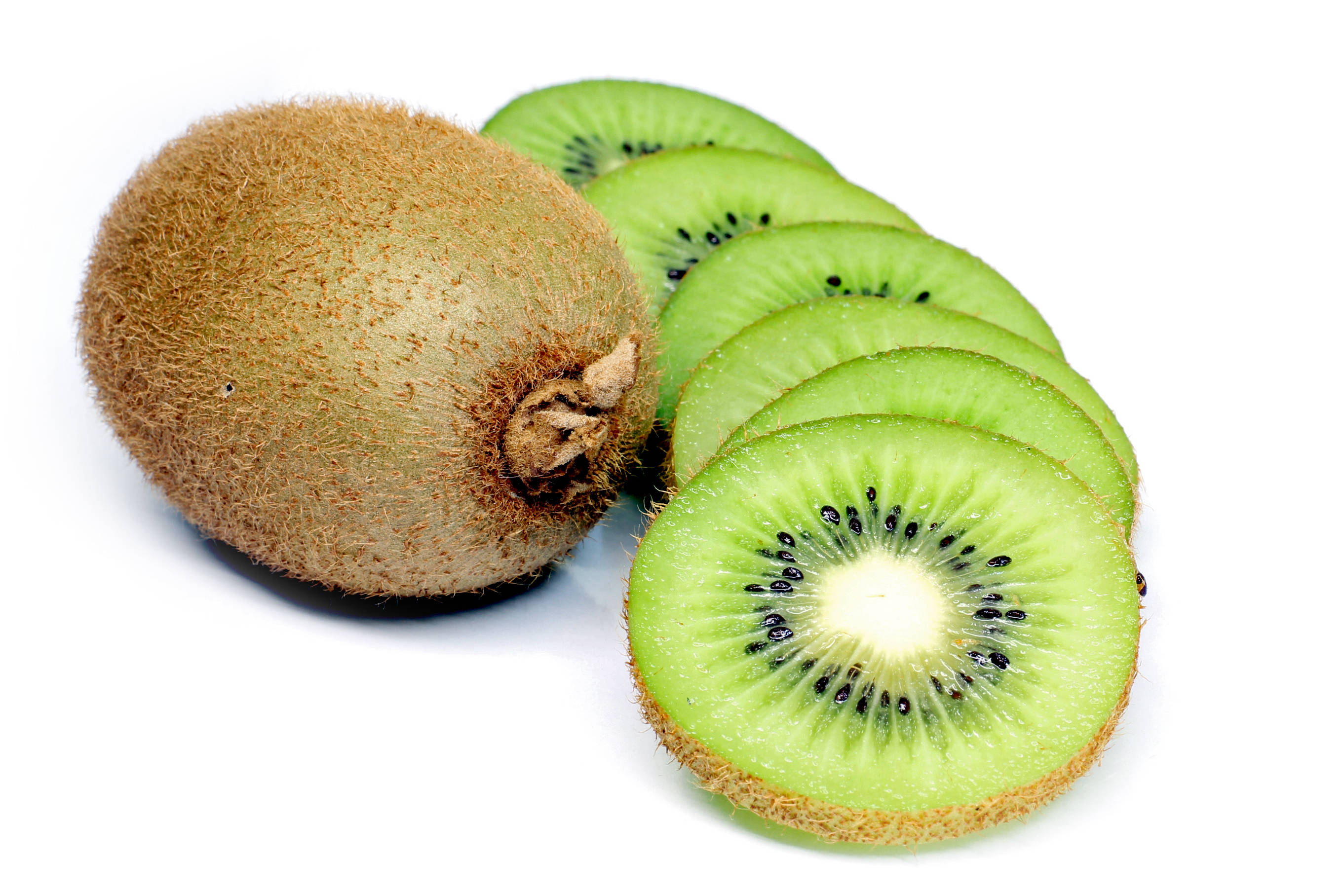 Appetizing Fruit Photography Of A Whole Kiwi Beside A Series Of Kiwi Slices Laid On Top Of Each Other