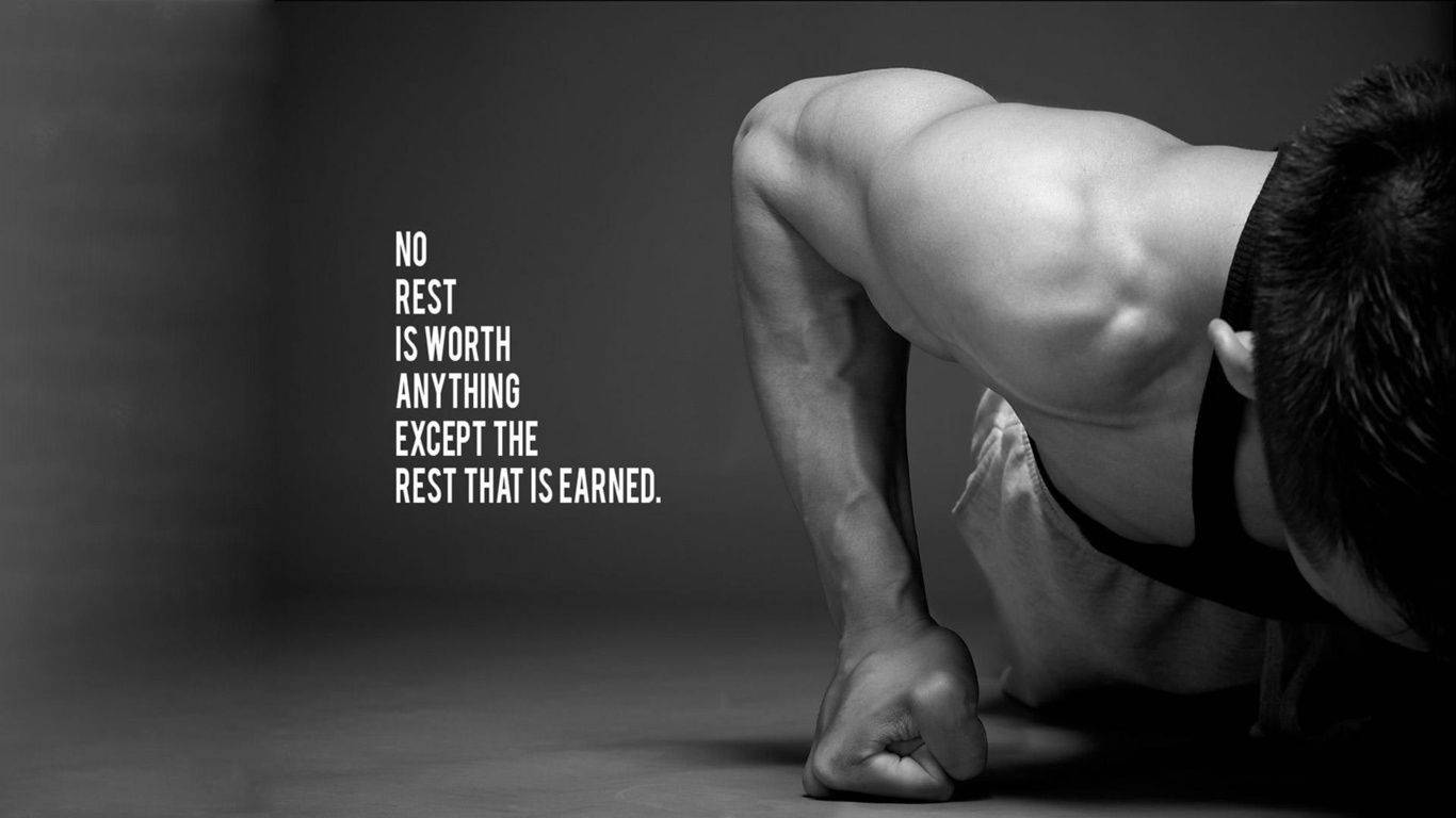 Black And White Picture Of A Muscular Man Doing Pushups With A Motivational Quote