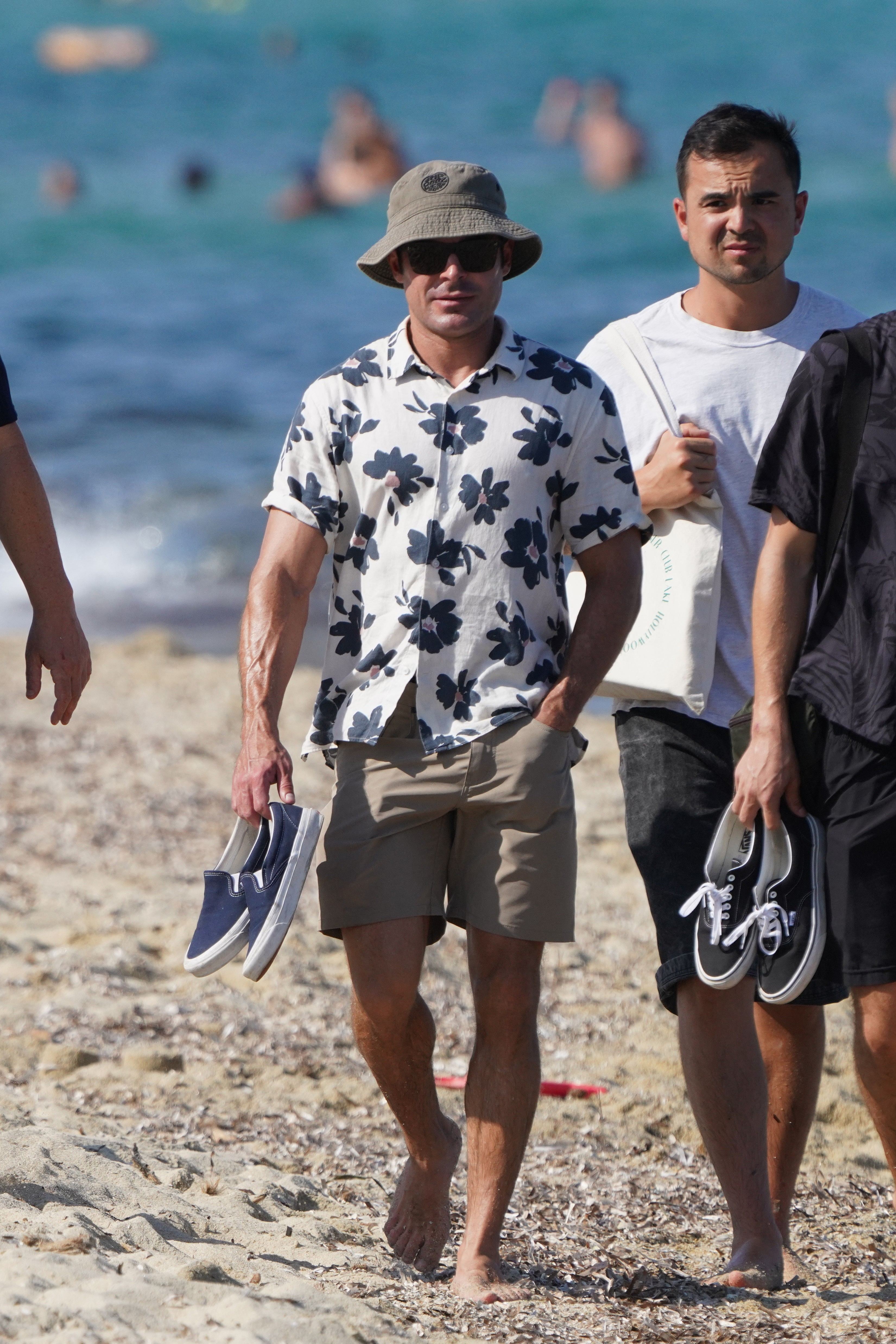 Zac Efron goes for an incognito walk on the beach